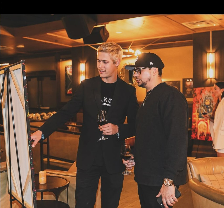 Zac Van Someren presenting a painting in progress at a venue